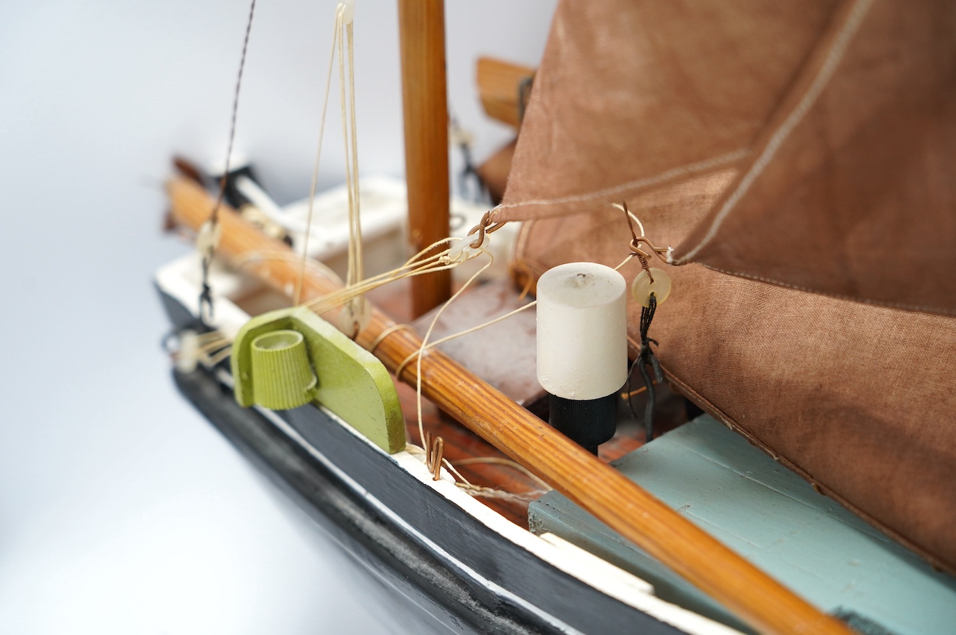 A painted wood pond yacht, 77cm in length. Condition - one mast broken